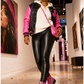 Pink Python Reloaded zebra and pink boots styled with black leather pants and varsity jacket in an art gallery